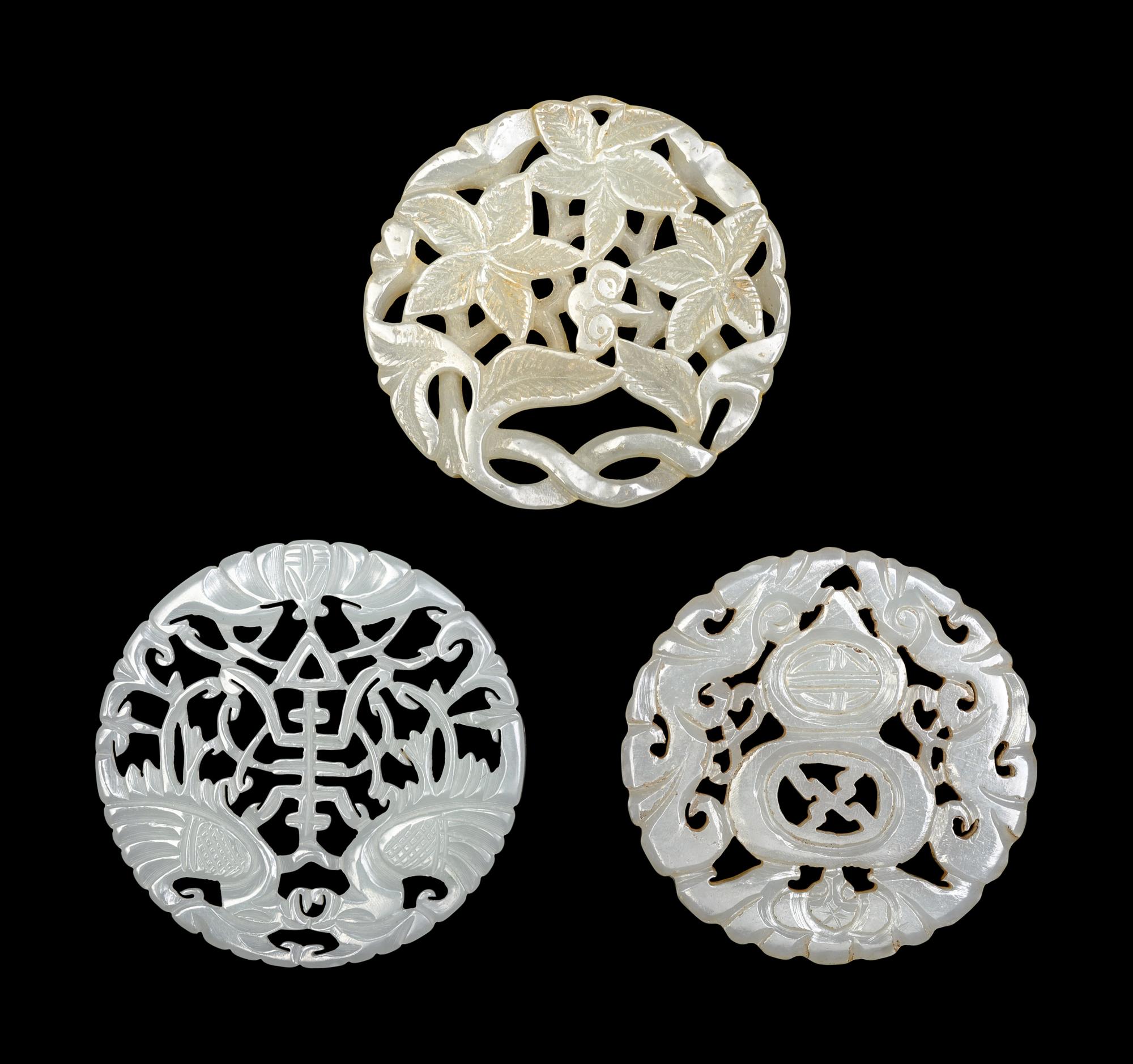 Three Chinese Pale Celadon Jade Circular Reticulated Plaques
