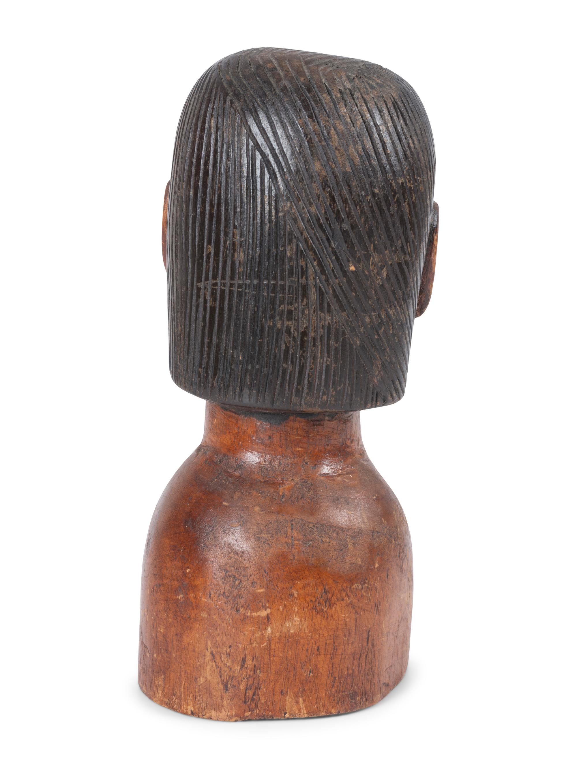 A Carved and Painted Wood Bust of a Mustachioed Man
