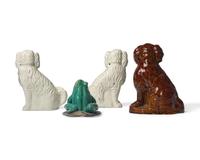 A Group of Four Ceramic Figures: Three Spaniels and a Frog