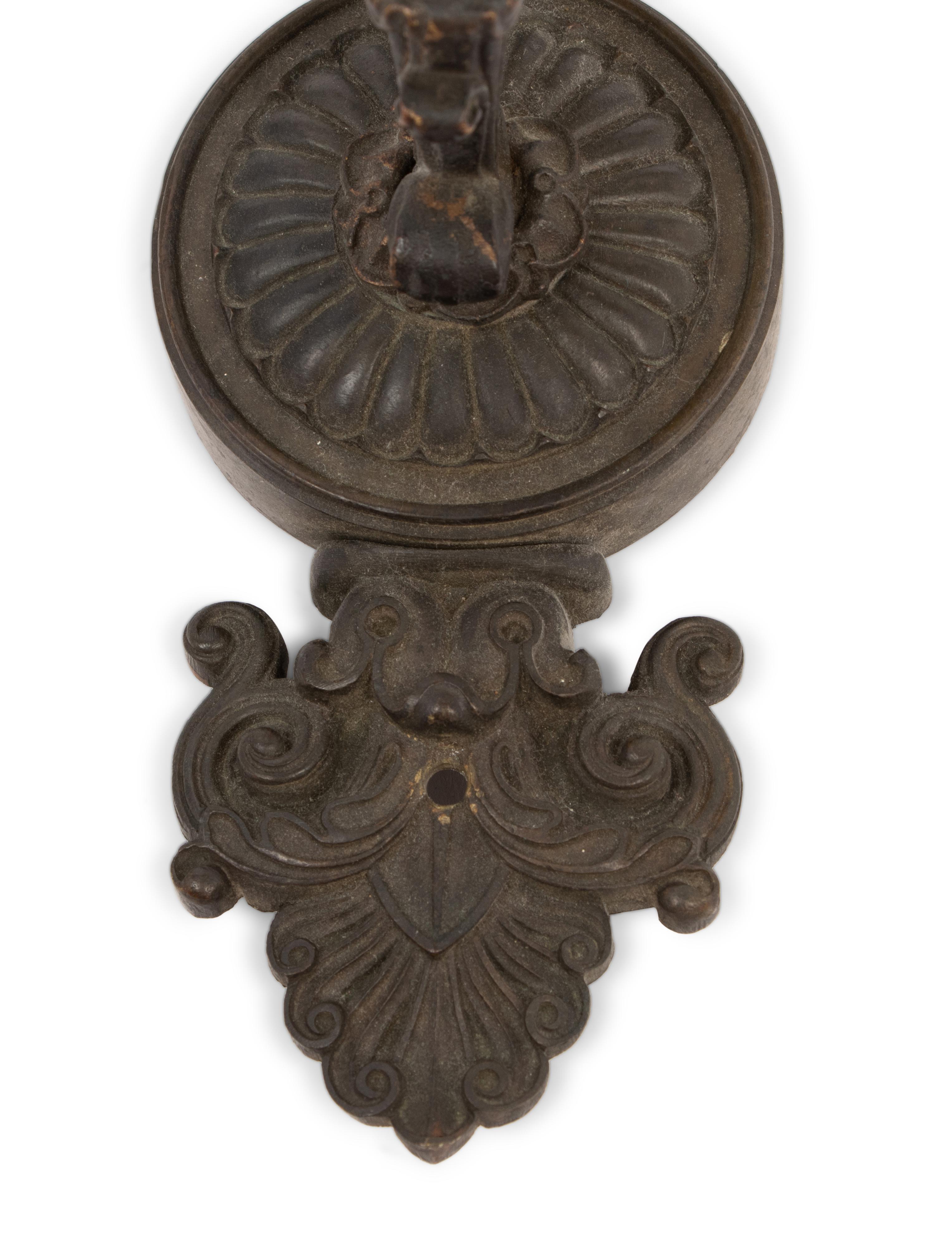 A Pair of Neoclassical Patinated Metal Three-Light Wall Sconces
