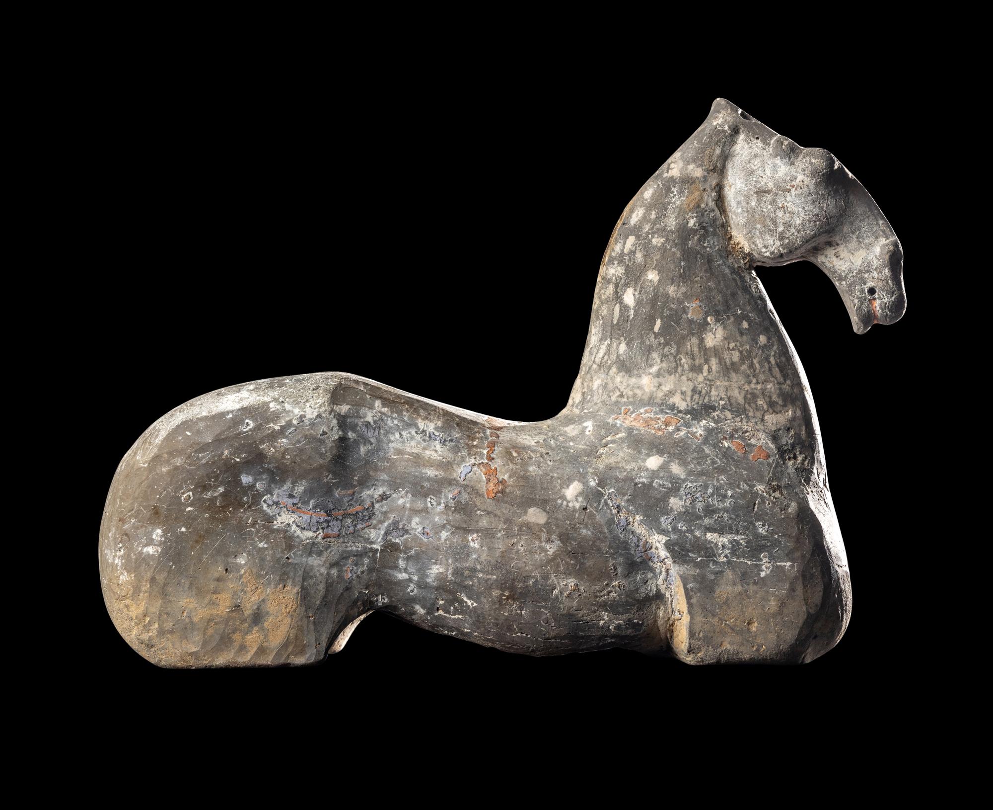 A Chinese Grey Pottery Figure of a Recumbent Horse