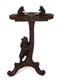 A Swiss Black Forest Carved Wood Smoking Table