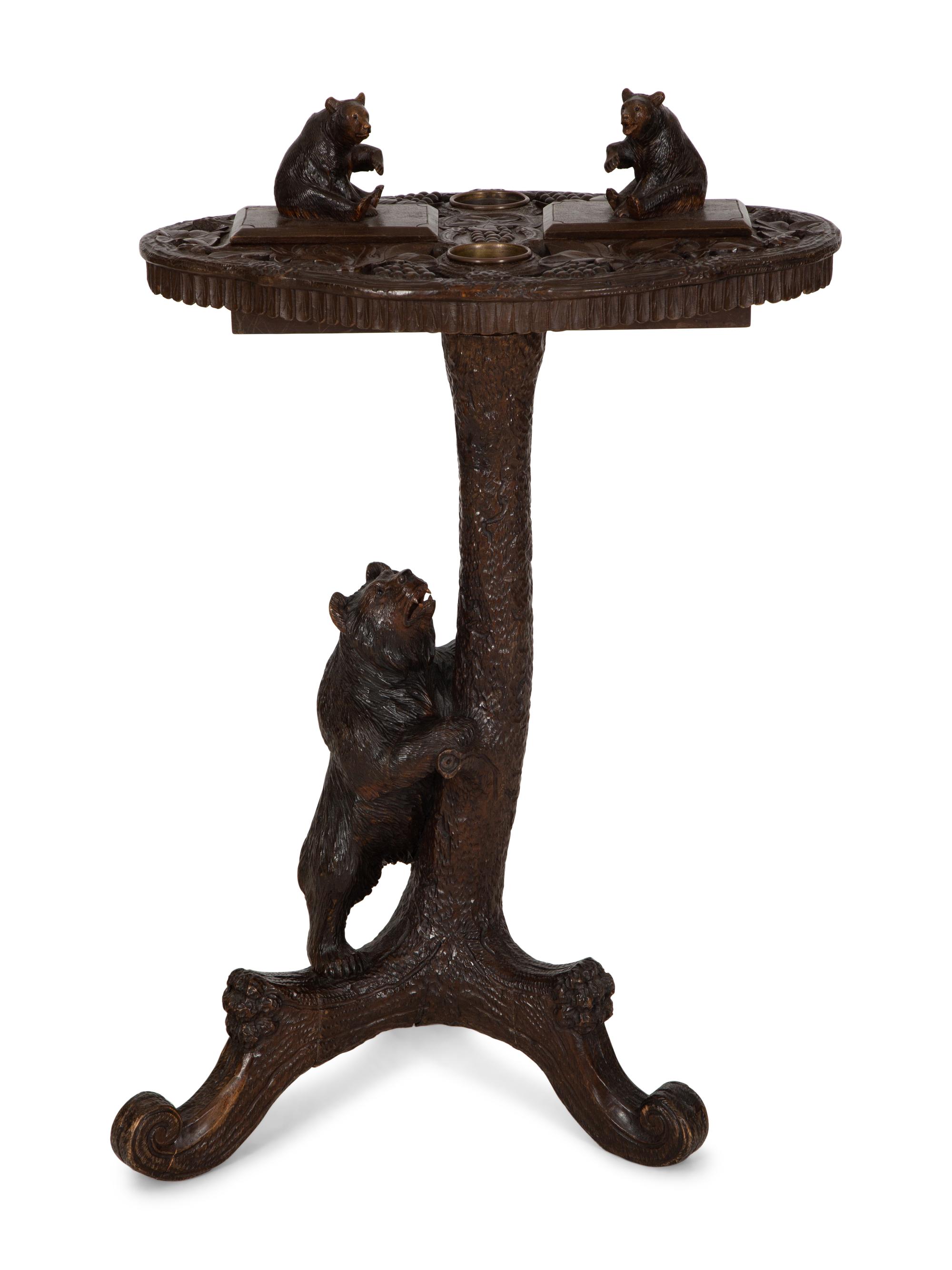 A Swiss Black Forest Carved Wood Smoking Table