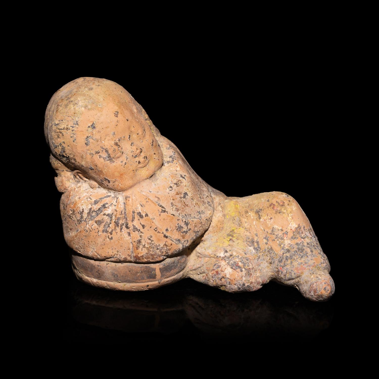 A Chinese Painted Pottery Figure of a Girl, Song Dynasty — 宋 彩繪陶臥女童