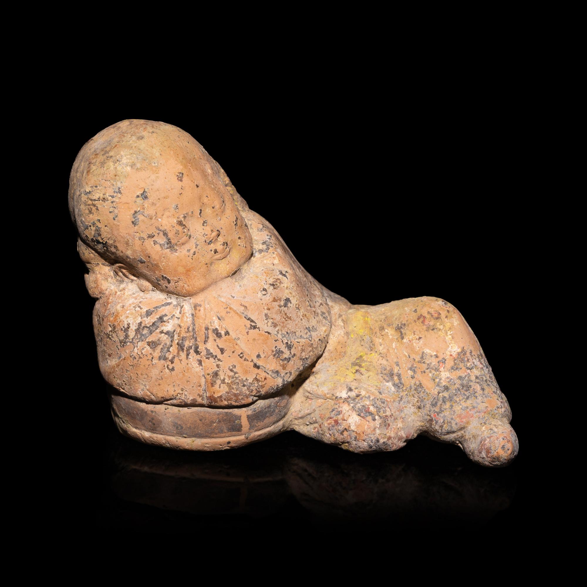 A Chinese Painted Pottery Figure of a Girl, Song Dynasty — 宋 彩繪陶臥女童
