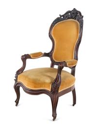 A Victorian Rococo Revival Carved Walnut Armchair