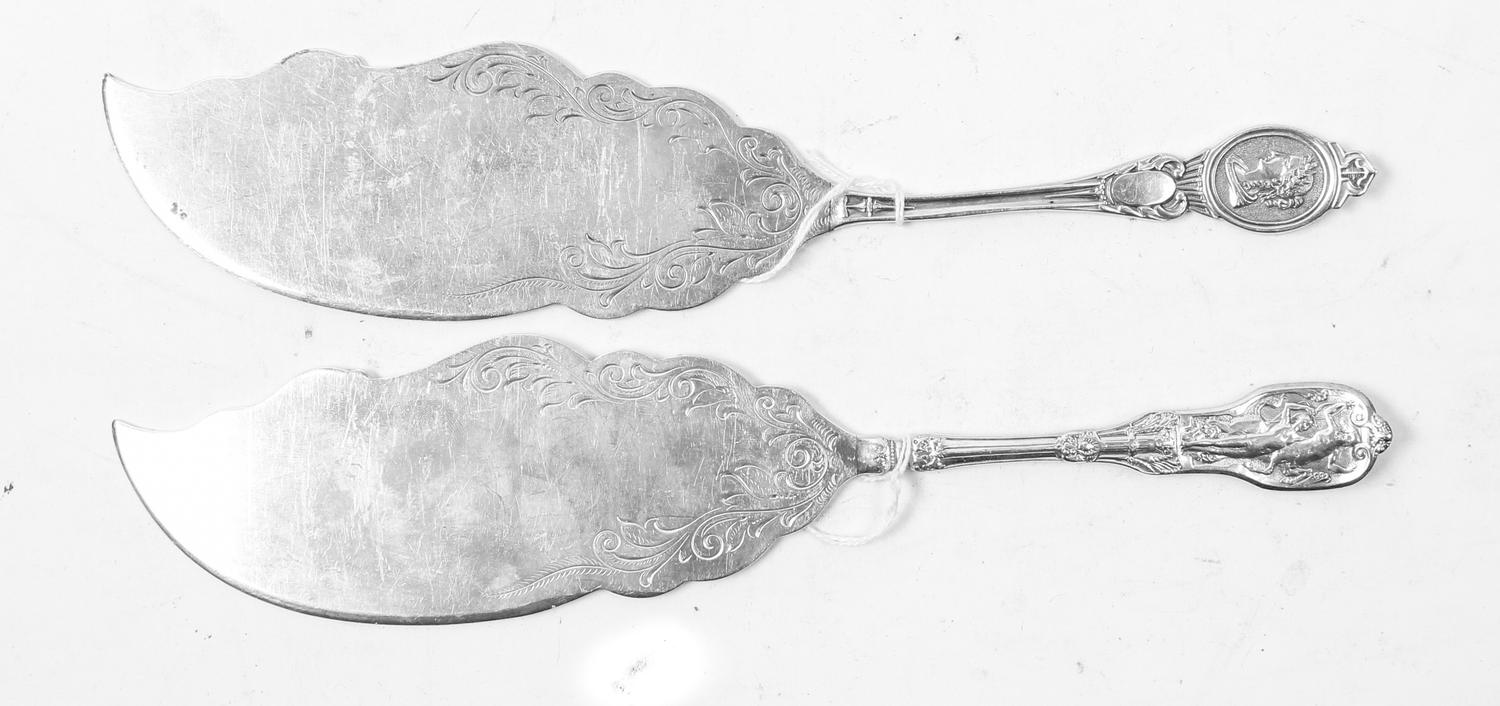 Two American Silver Fish Slices, , each with handles decorated with classical scenes, the blades chased with foliate and volute decorat