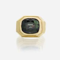 A color change alexandrite and eighteen karat gold ring