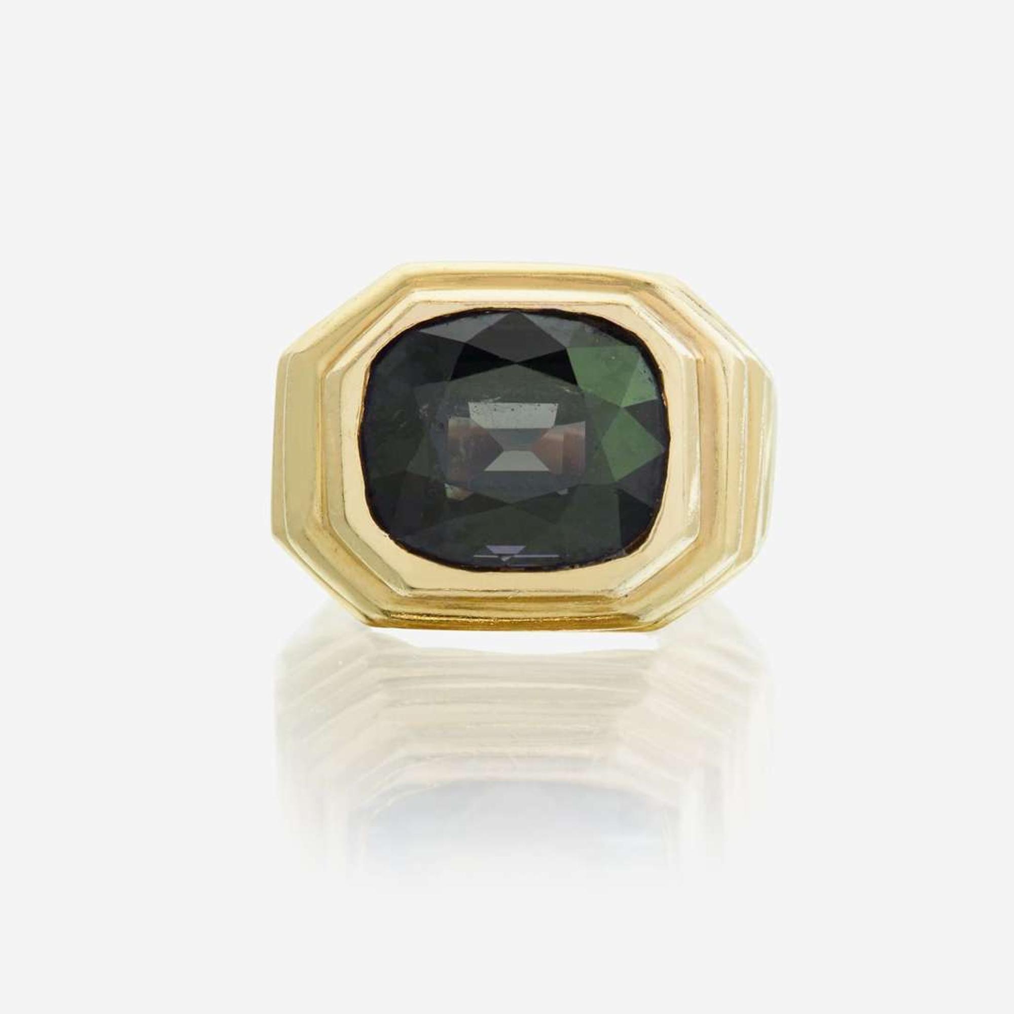 A color change alexandrite and eighteen karat gold ring