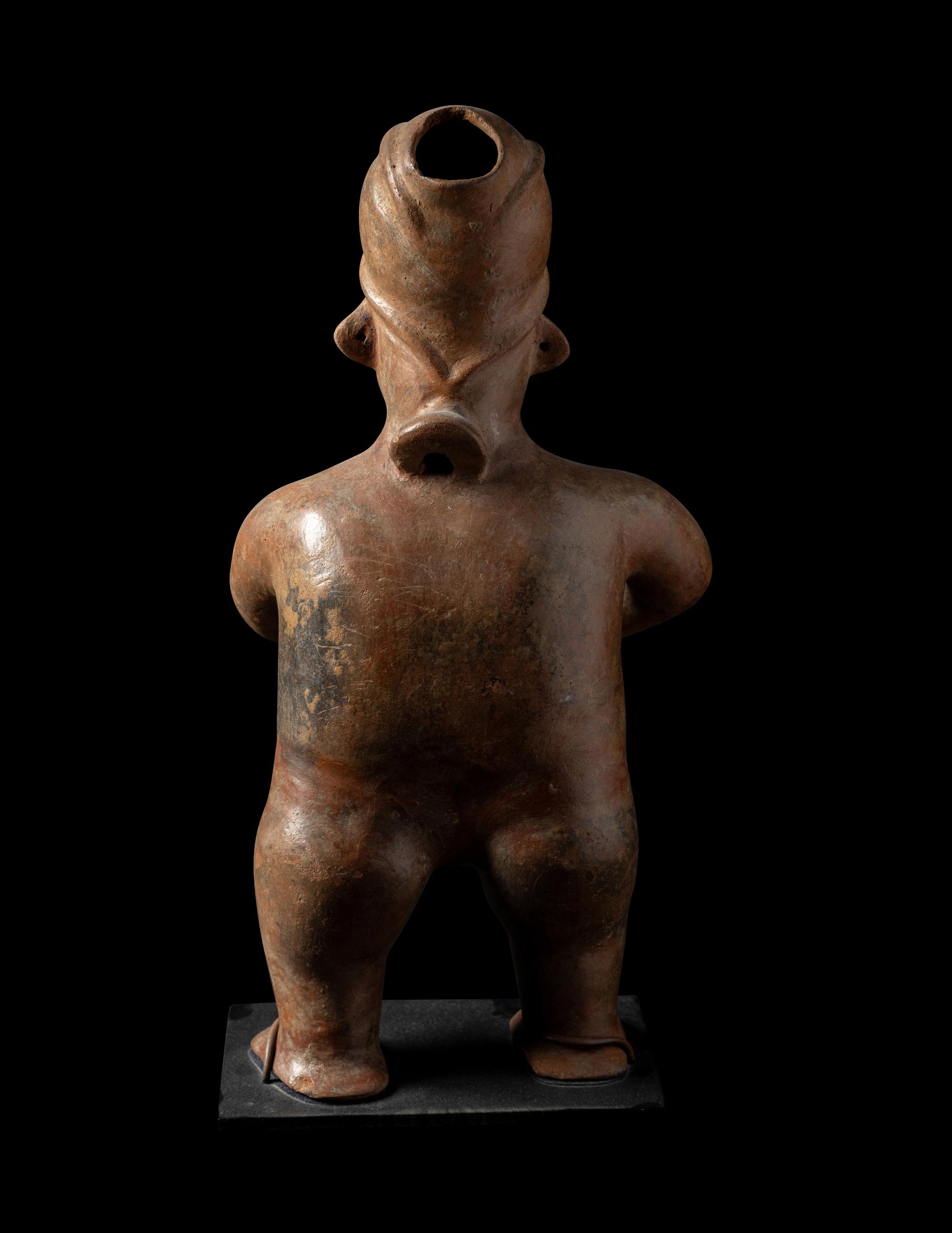 A Colima Standing Figure Holding a Pot