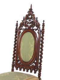 A Pair of Gothic Revival Carved Walnut Side Chairs