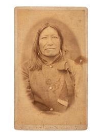 [NATIVE AMERICANS]. CROSS, William R., photographer. A group of 2 CDVs of Sioux subjects including Sitting Bull's prisoner of war camp. Niobrara, NE: n.d.