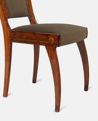An Austrian Secessionist Inlaid Dining Suite, comprising a sideboard, a server, an extension dining table with five leaves, six side chairs and four armchairs