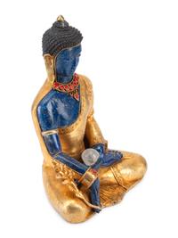 A Tibetan Style Gilt Bronze and Lapis Lazuli Seated Deity