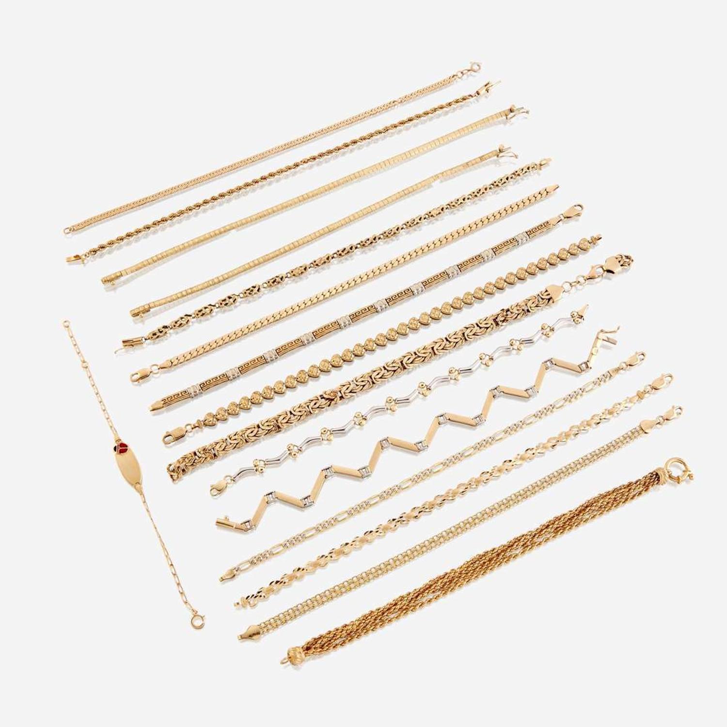 A collection of sixteen fourteen karat gold bracelets