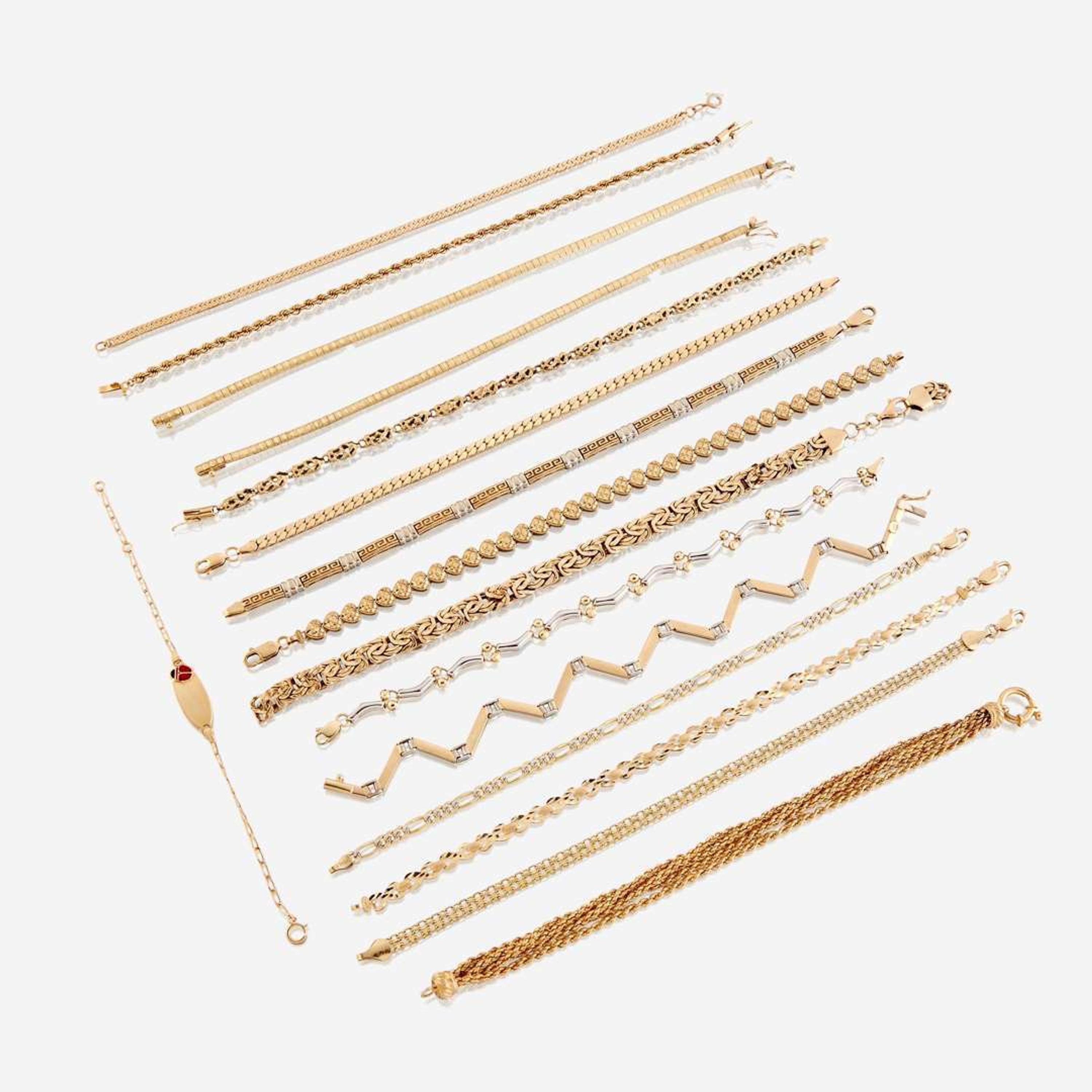 A collection of sixteen fourteen karat gold bracelets