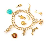 A 14 Karat Yellow Gold Charm Bracelet with 12 Attached and Unattached Charms, 27.10 dwts.
