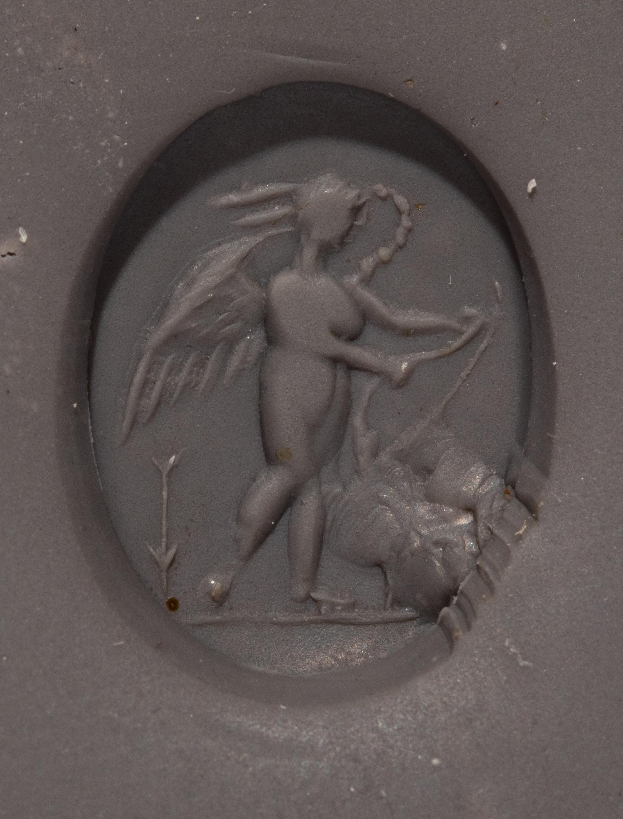 A Roman Amethyst Intaglio with Eros Stringing His Bow