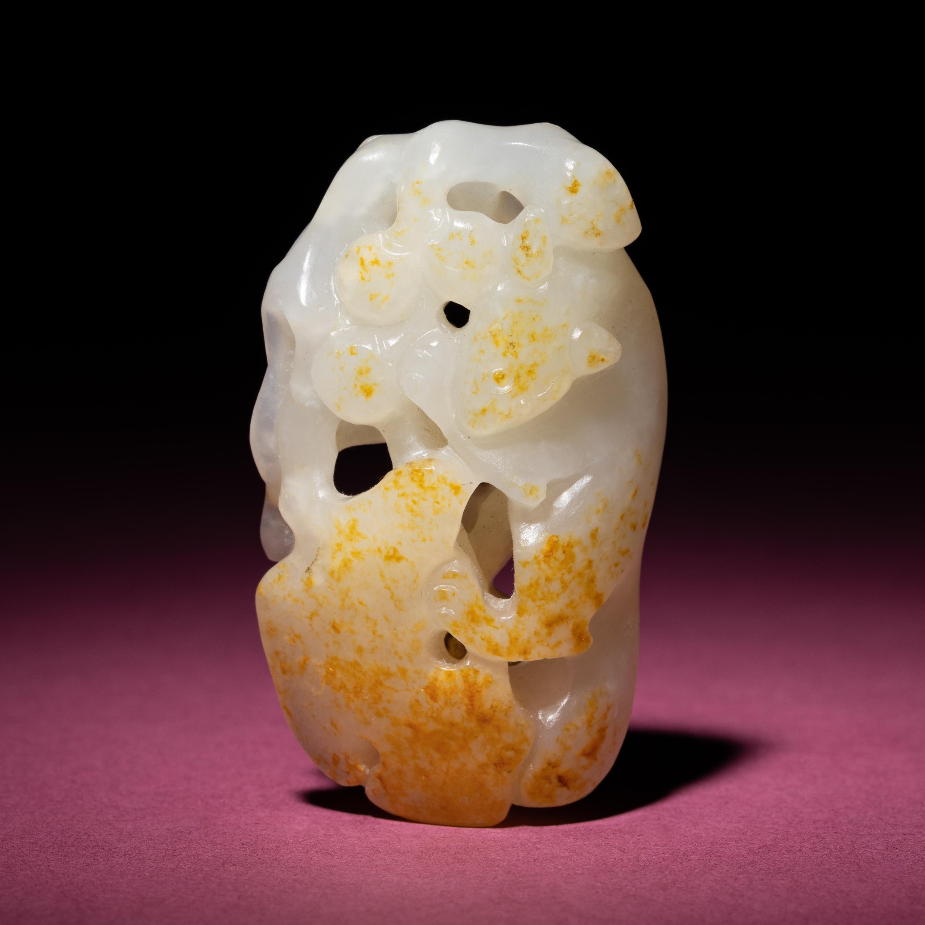 A Chinese Russet and White Jade 'Squirrel and Grape' Carving, 18th/19th Century — 清中期 白玉留皮松鼠葡萄
