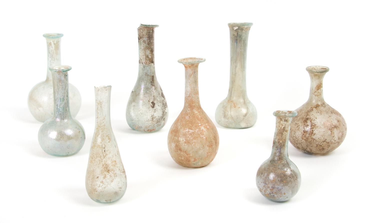 A Collection of Eight Roman Glass Flasks and Unguentariums, Height of tallest 3 7/8 inches.