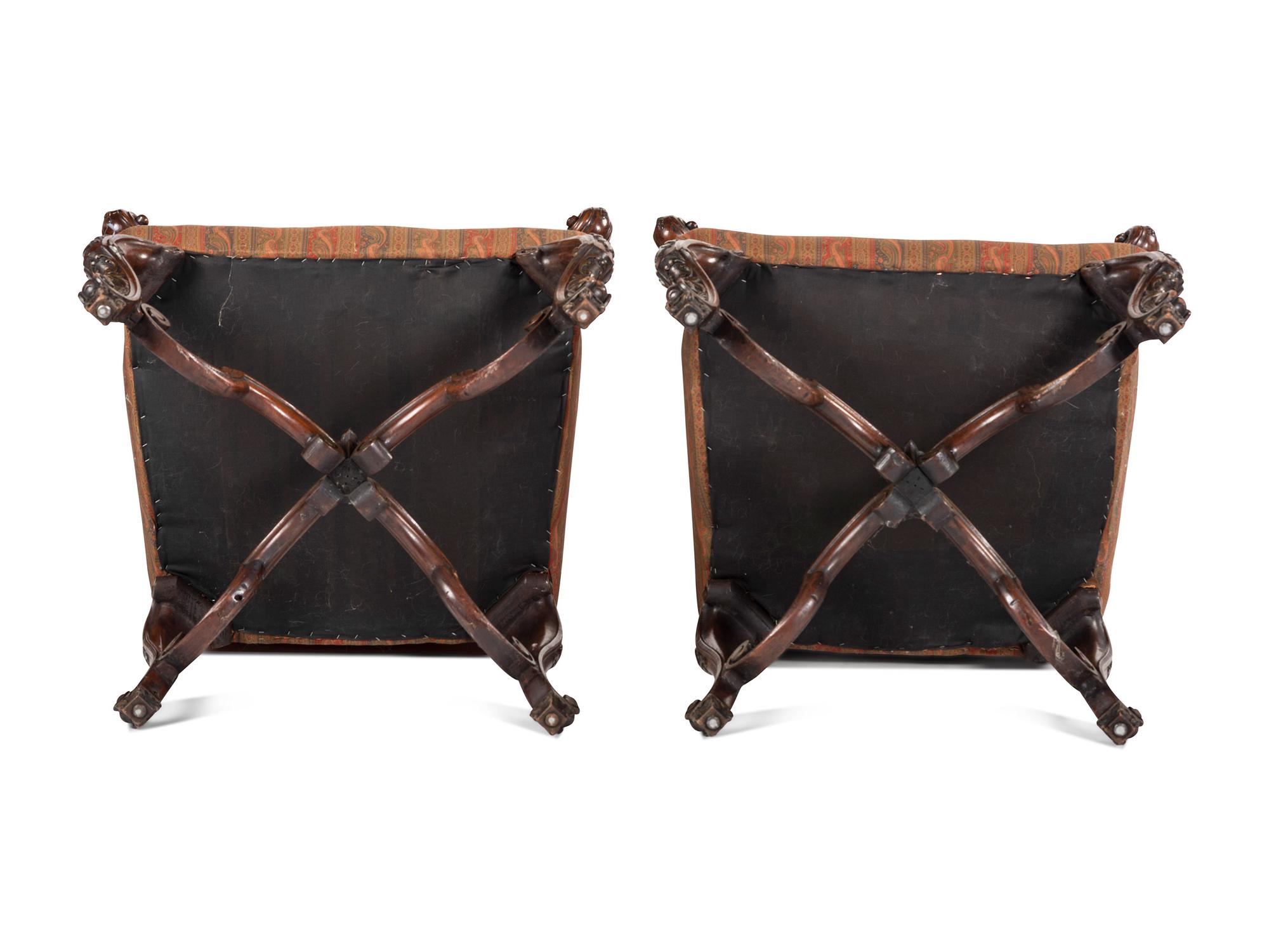 A Pair of Louis XV Style Carved Walnut Fauteuils