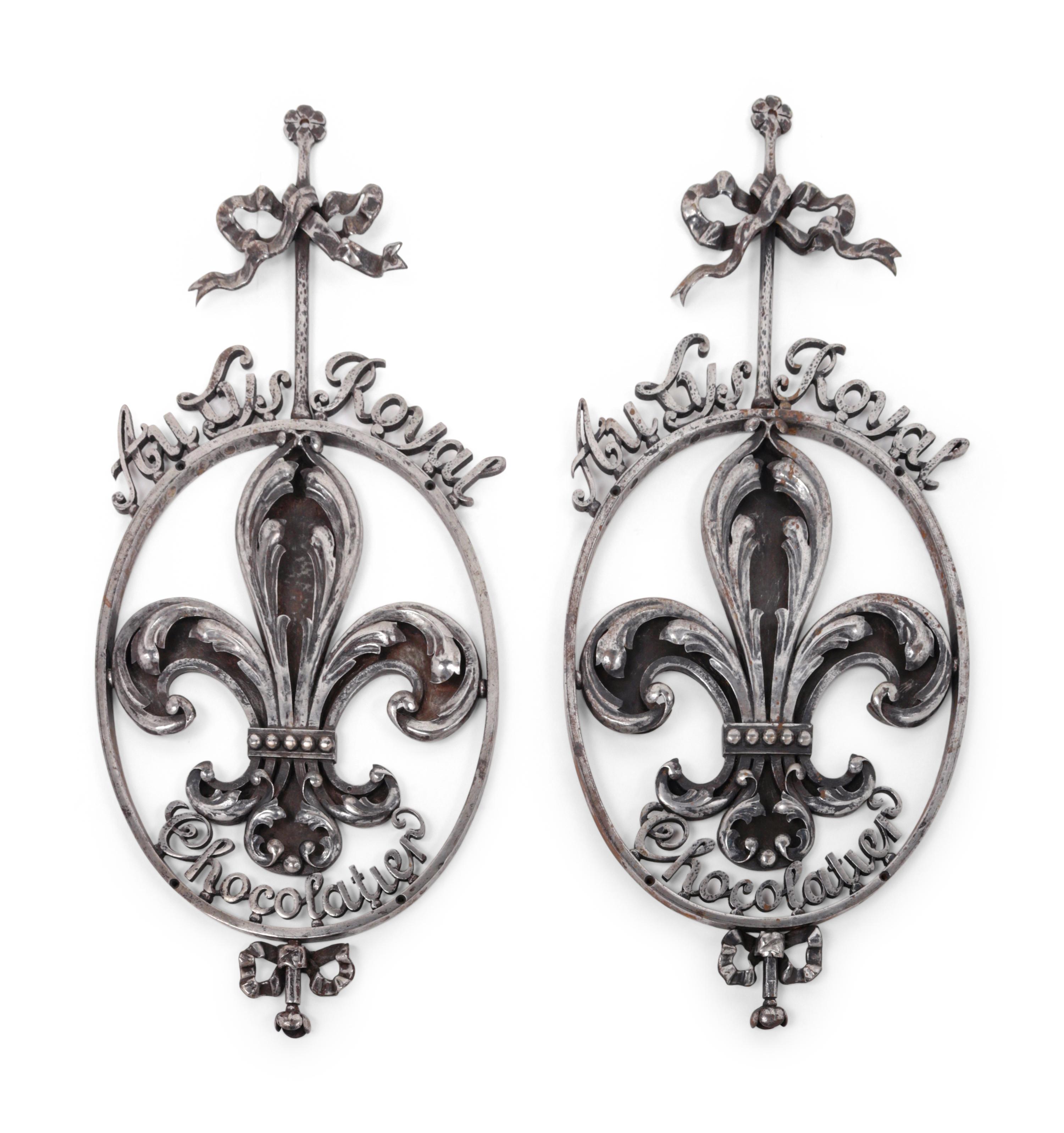 A Pair of French Wrought Iron or Steel Chocolatier's Trade Signs