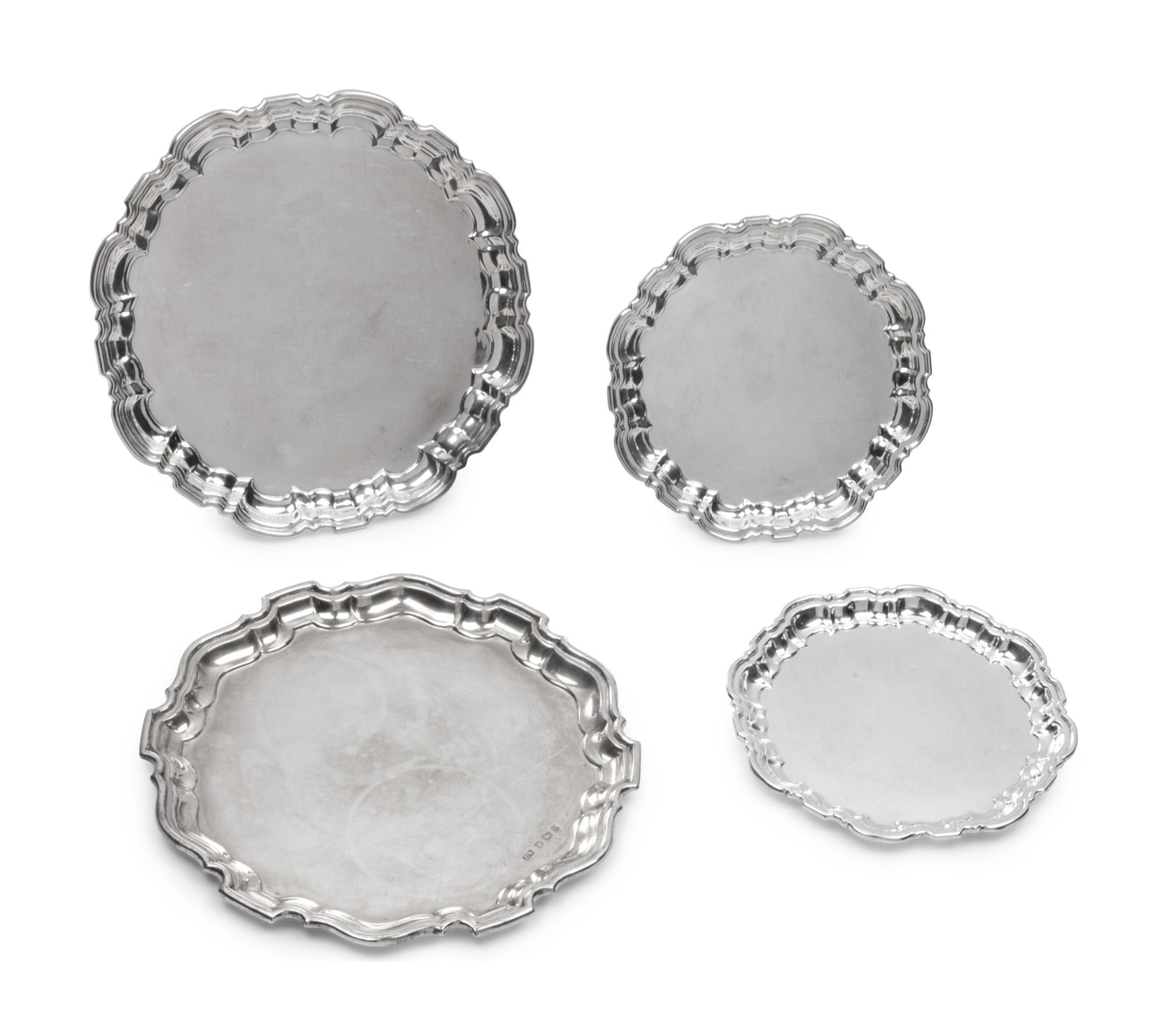A Group of Four English Silver Waiters