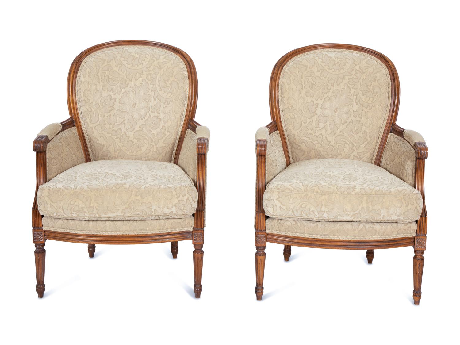 A Pair of Louis XVI Style Carved Walnut Bergères