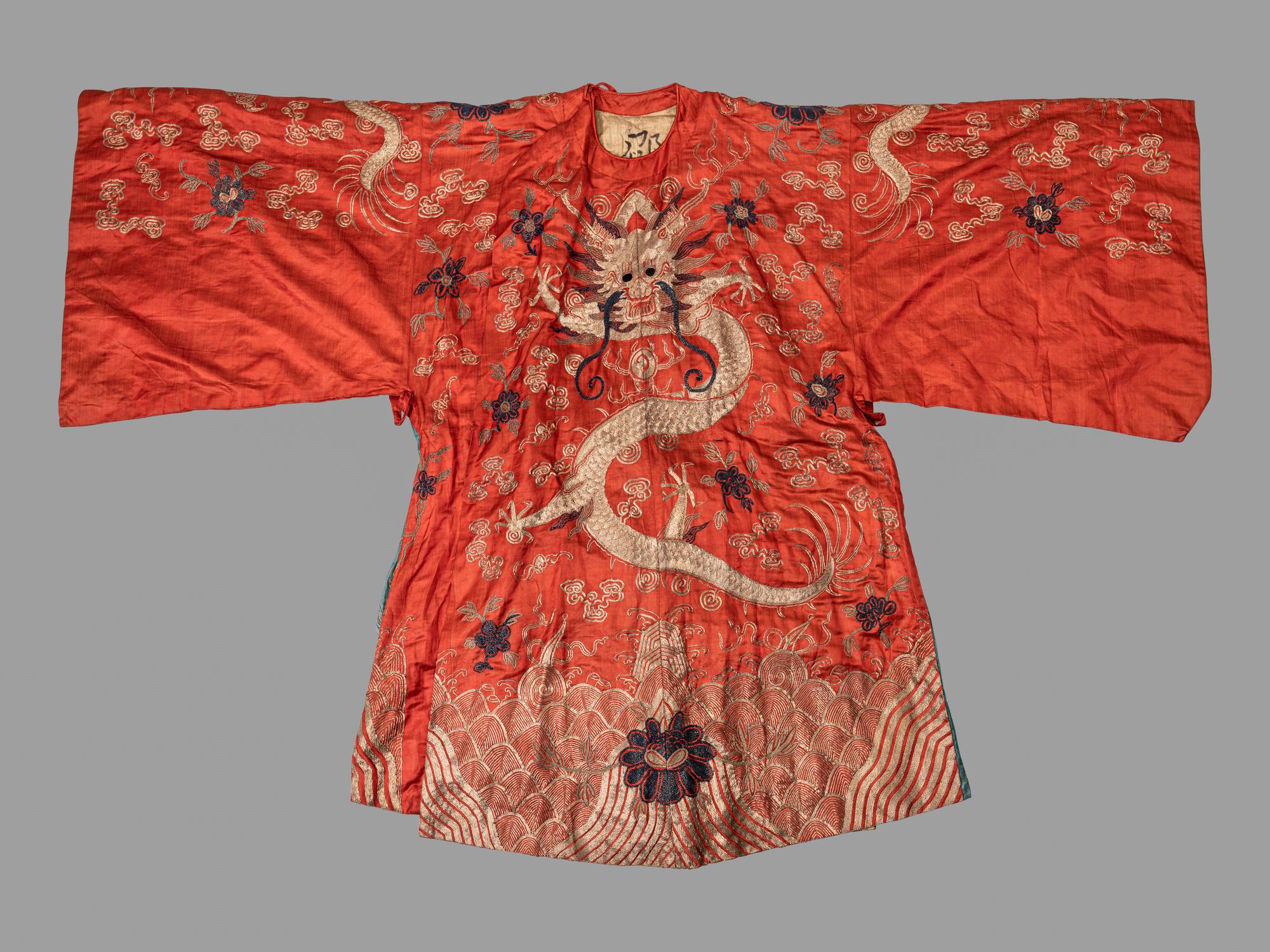 A Chinese Orange Ground Embroidered Silk Theatrical Dragon Robe