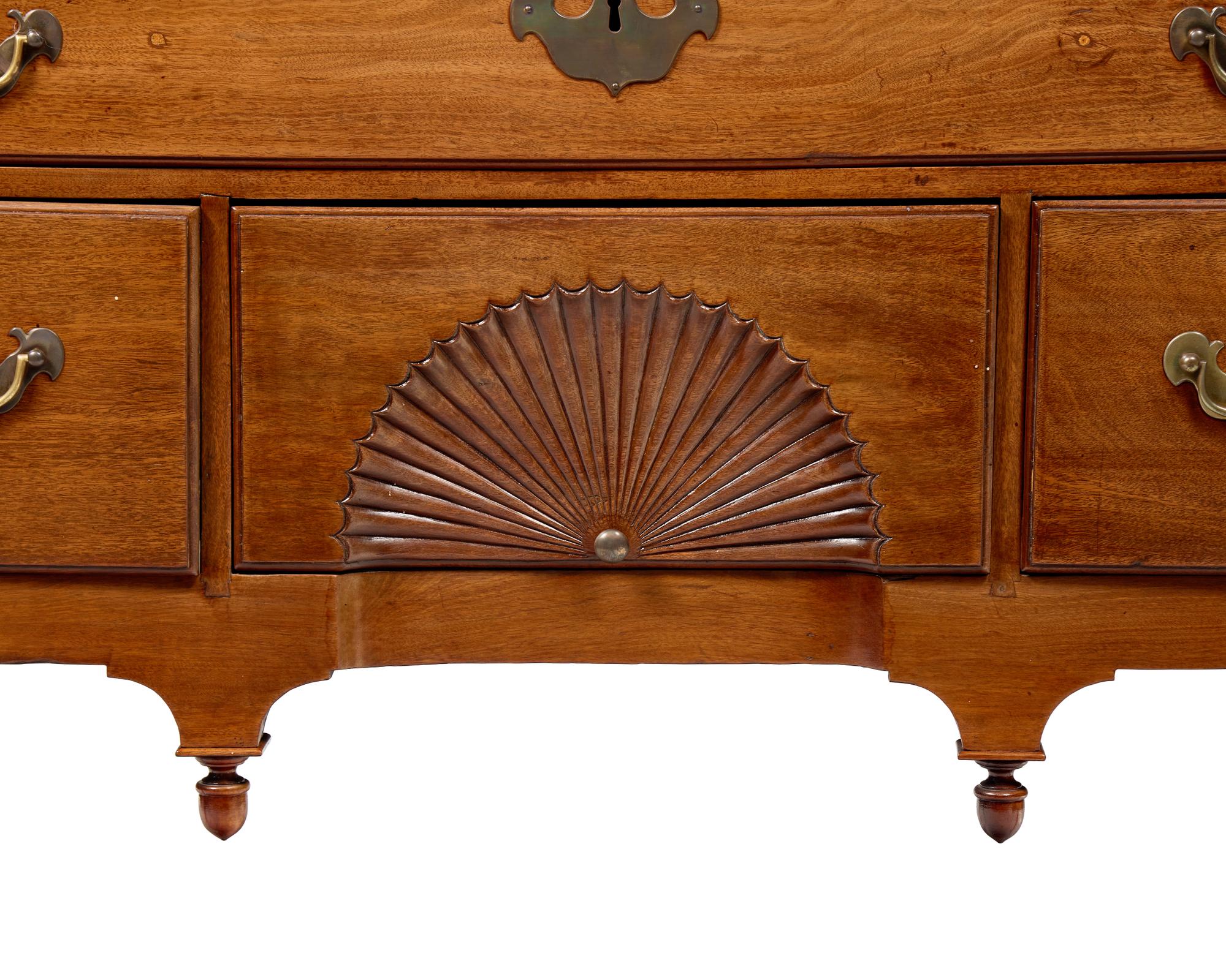 A Queen Anne Carved Walnut Bonnet-Top High Chest of Drawers