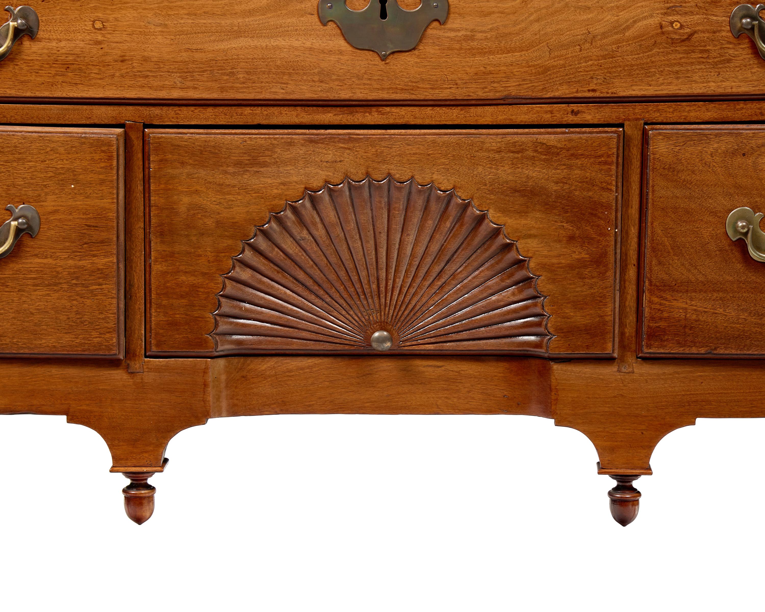 A Queen Anne Carved Walnut Bonnet-Top High Chest of Drawers