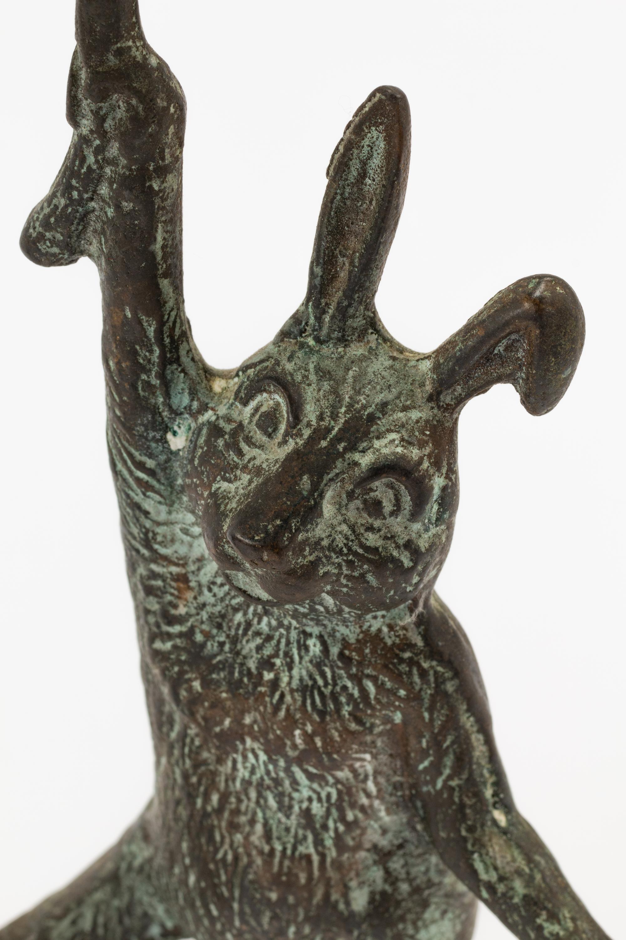 A Pair of Patinated Cast Metal Rabbit Candlesticks