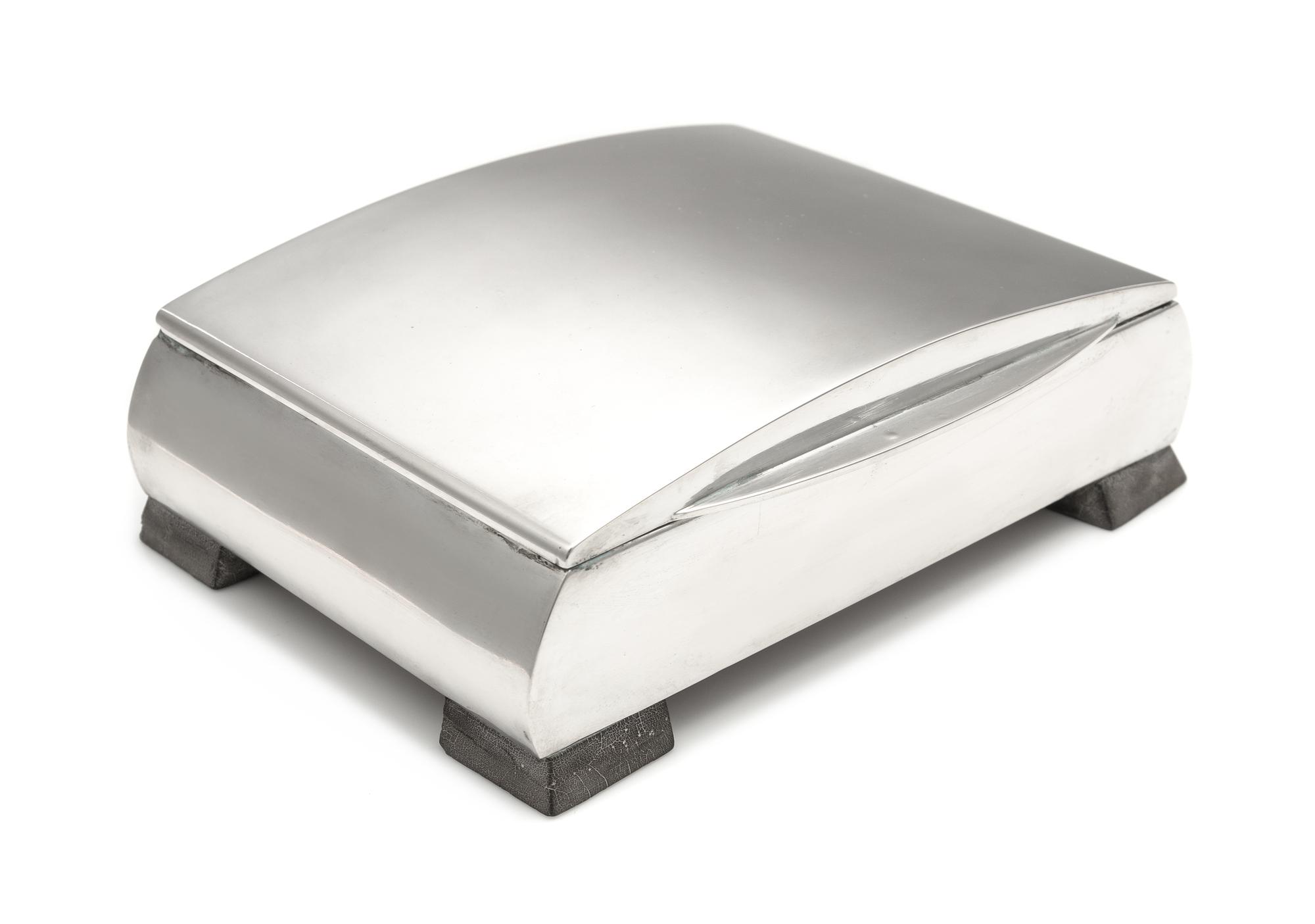 A Hungarian Silver Table Top Cigarette Case, Maker's Mark TL, Second Quarter 20th Century, the bowed lid above the conforming case, rai