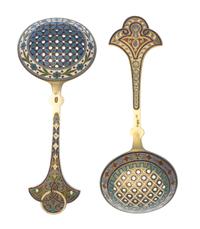Two Russian Silver-Gilt and Enamel Tea Strainers, Marks likely of Antip Kuzmichev, Moscow, late 19th century, each with a flared handle