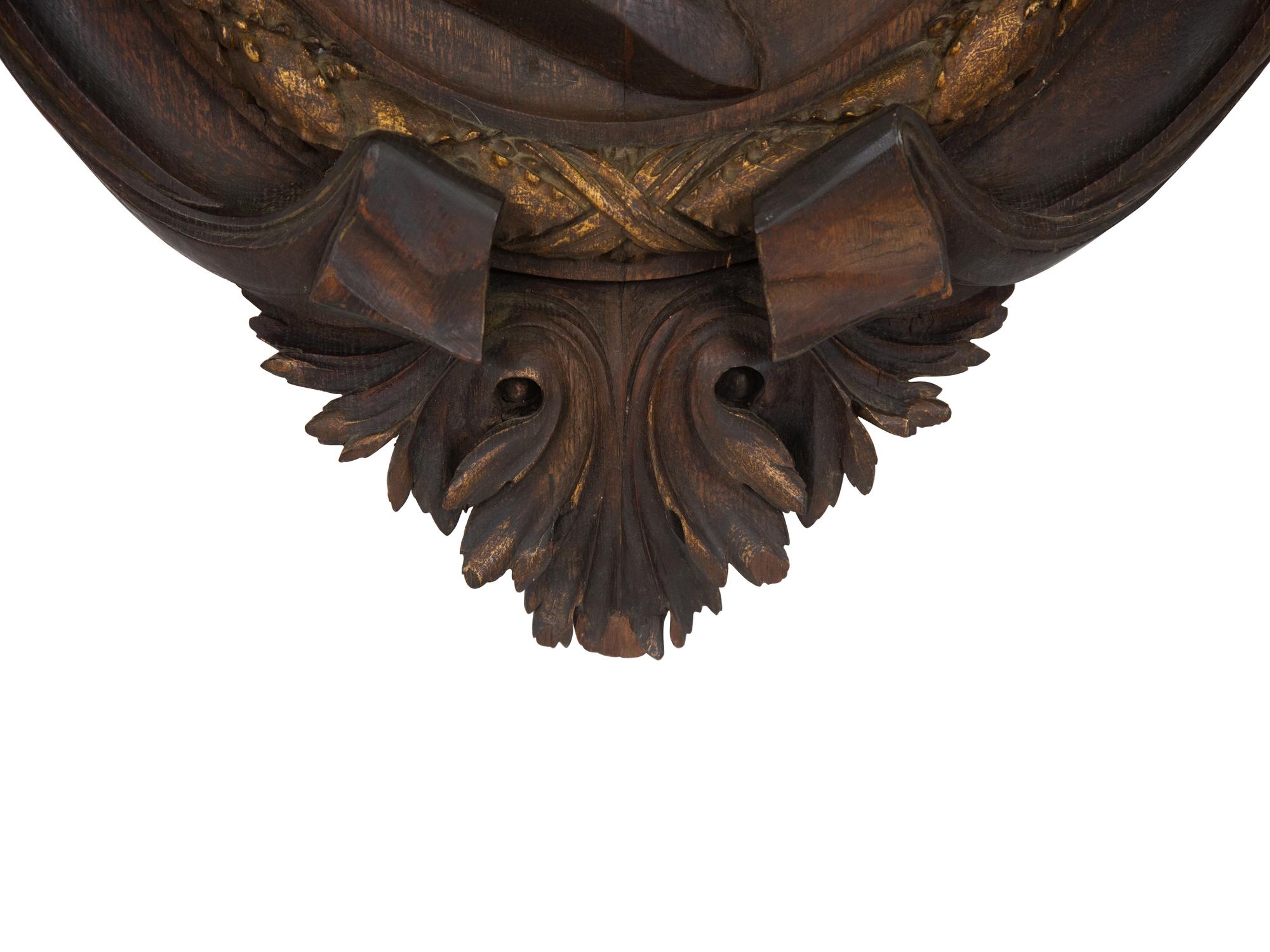 A Pair of Continental Carved Oak and Parcel Gilt Profile Plaques