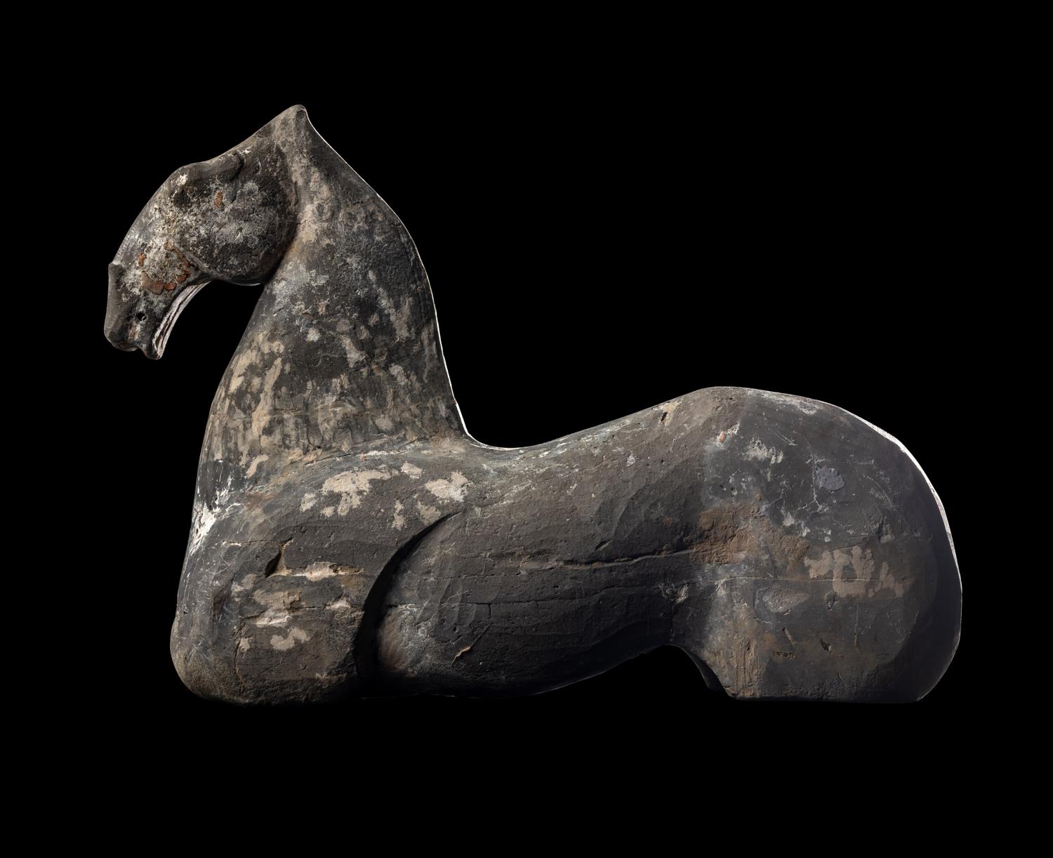 A Chinese Grey Pottery Figure of a Recumbent Horse