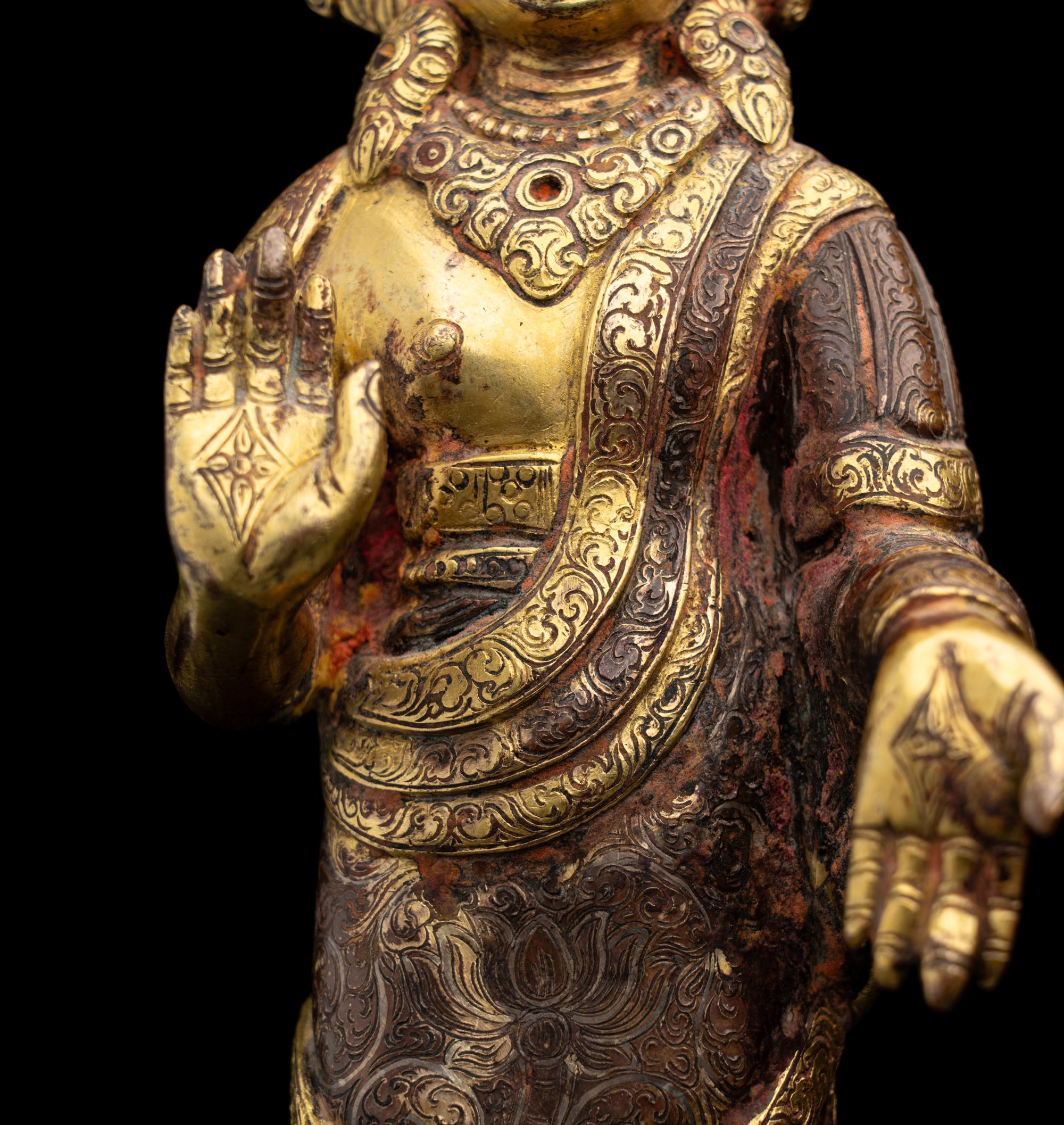 A Nepalese Gilt Bronze Standing Figure of Dipankara