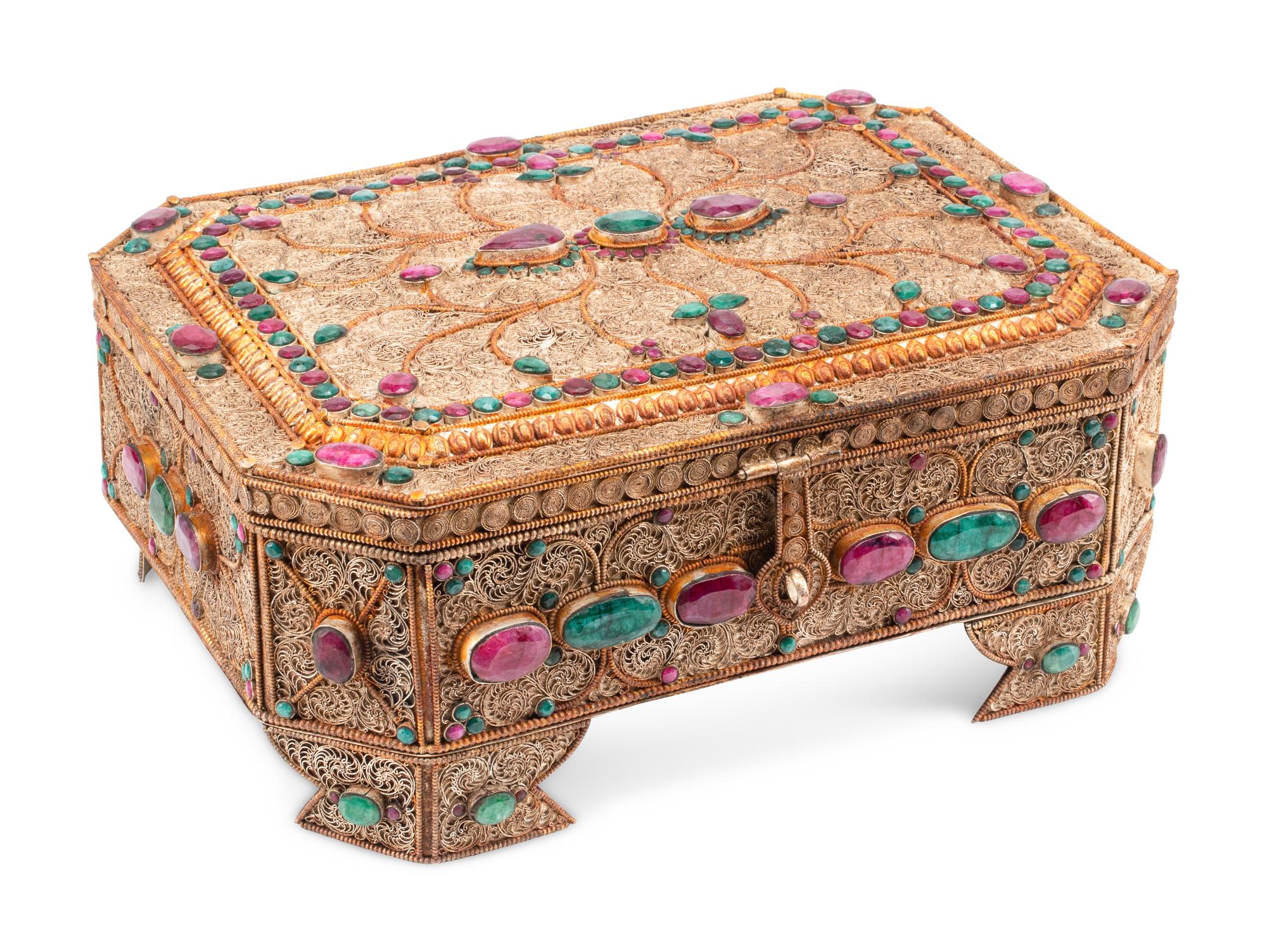 An Emerald and Ruby Mounted Silvered Metal Filigree Box