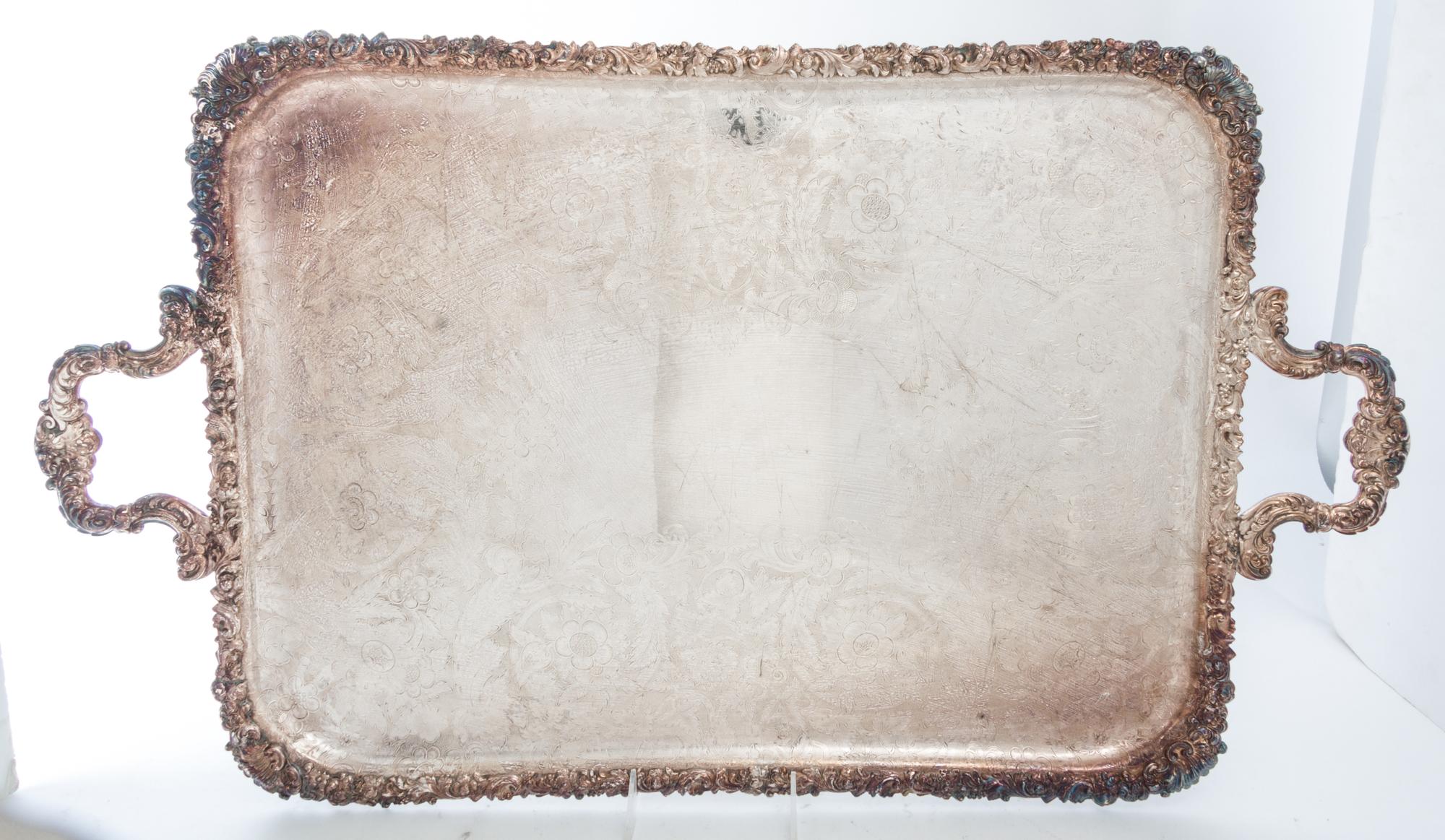 A Group of Silver-Plate Serving Trays Width of widest over handles 30 inches.