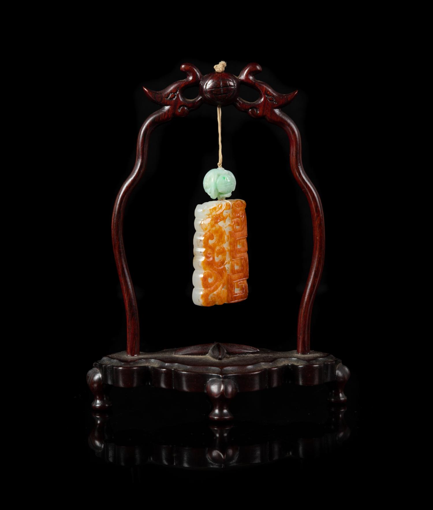 A Celadon and Russet Jade Reticulated Plaque