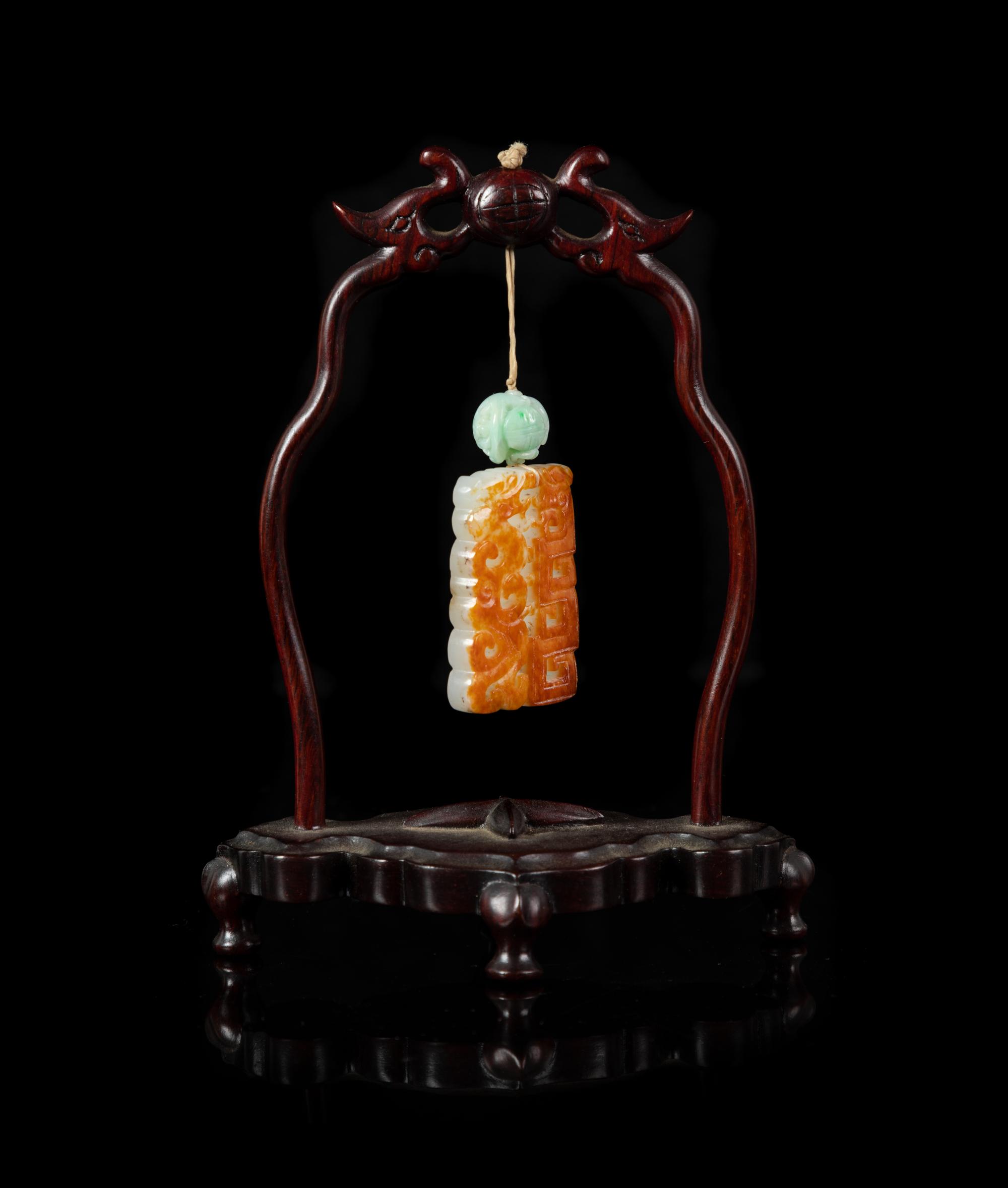 A Celadon and Russet Jade Reticulated Plaque