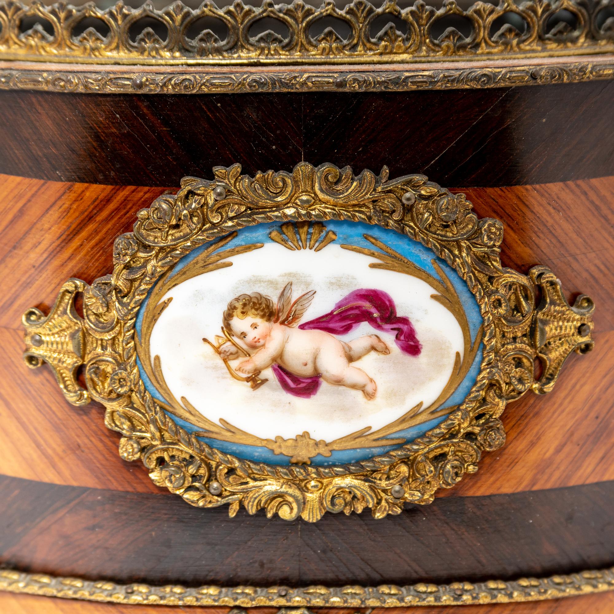A French Porcelain and Gilt Bronze Mounted Kingwood Jardinière