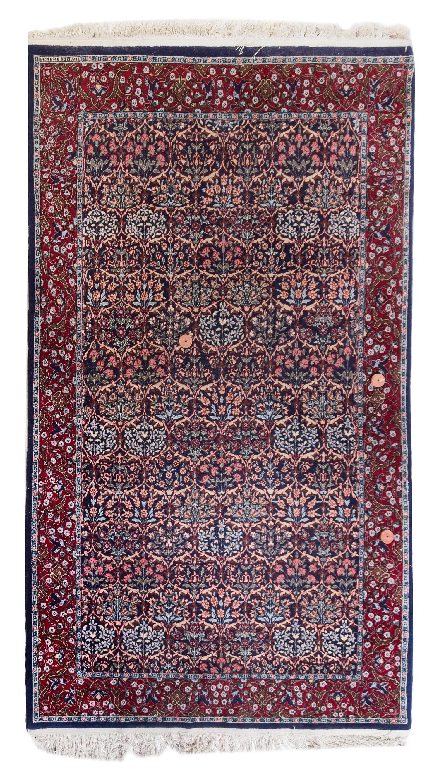 A Hereke Wool Rug 8 feet 2 inches x 5 feet.