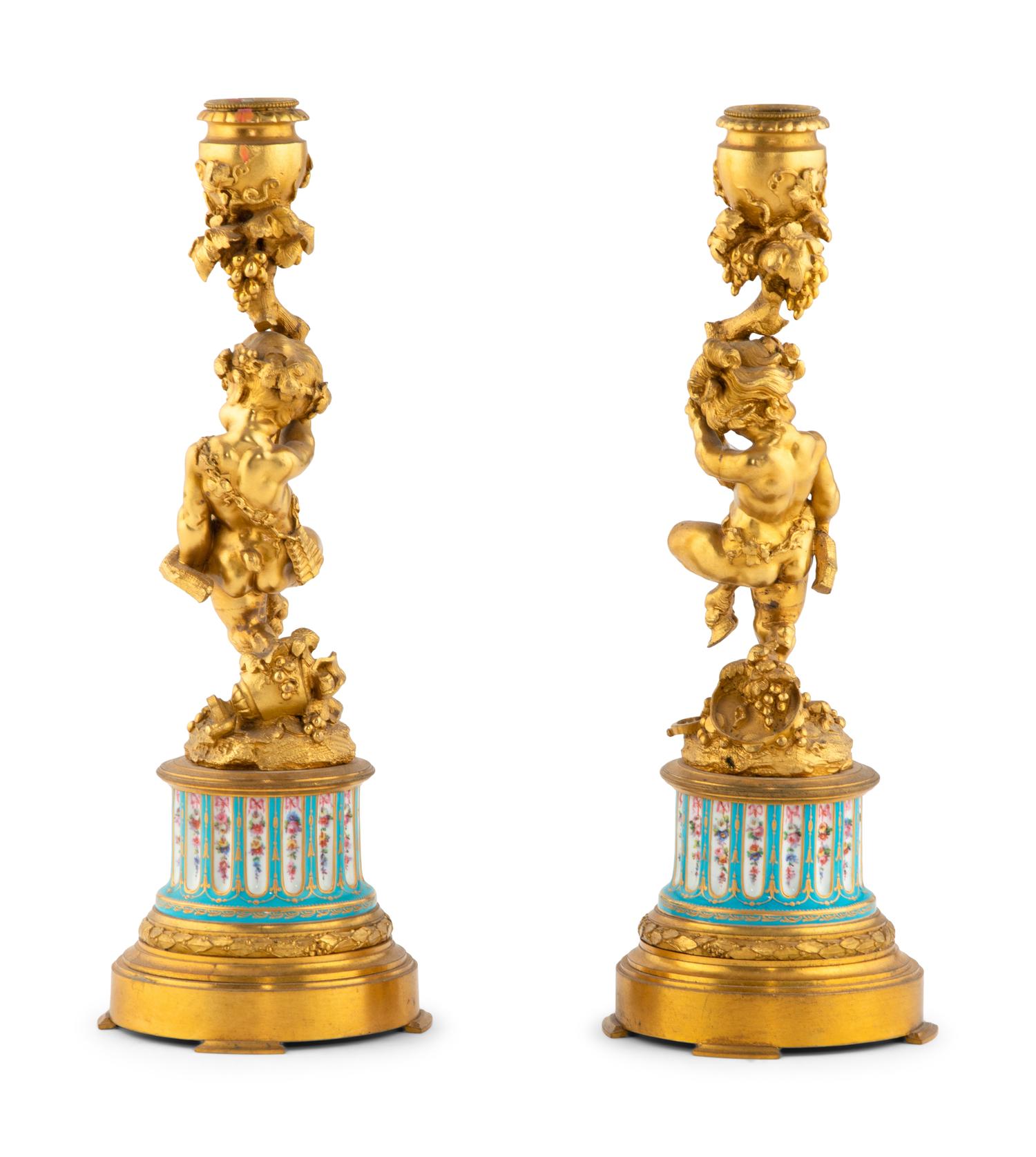 A Pair of French Gilt Bronze and Bourdin Porcelain Figural Candlesticks