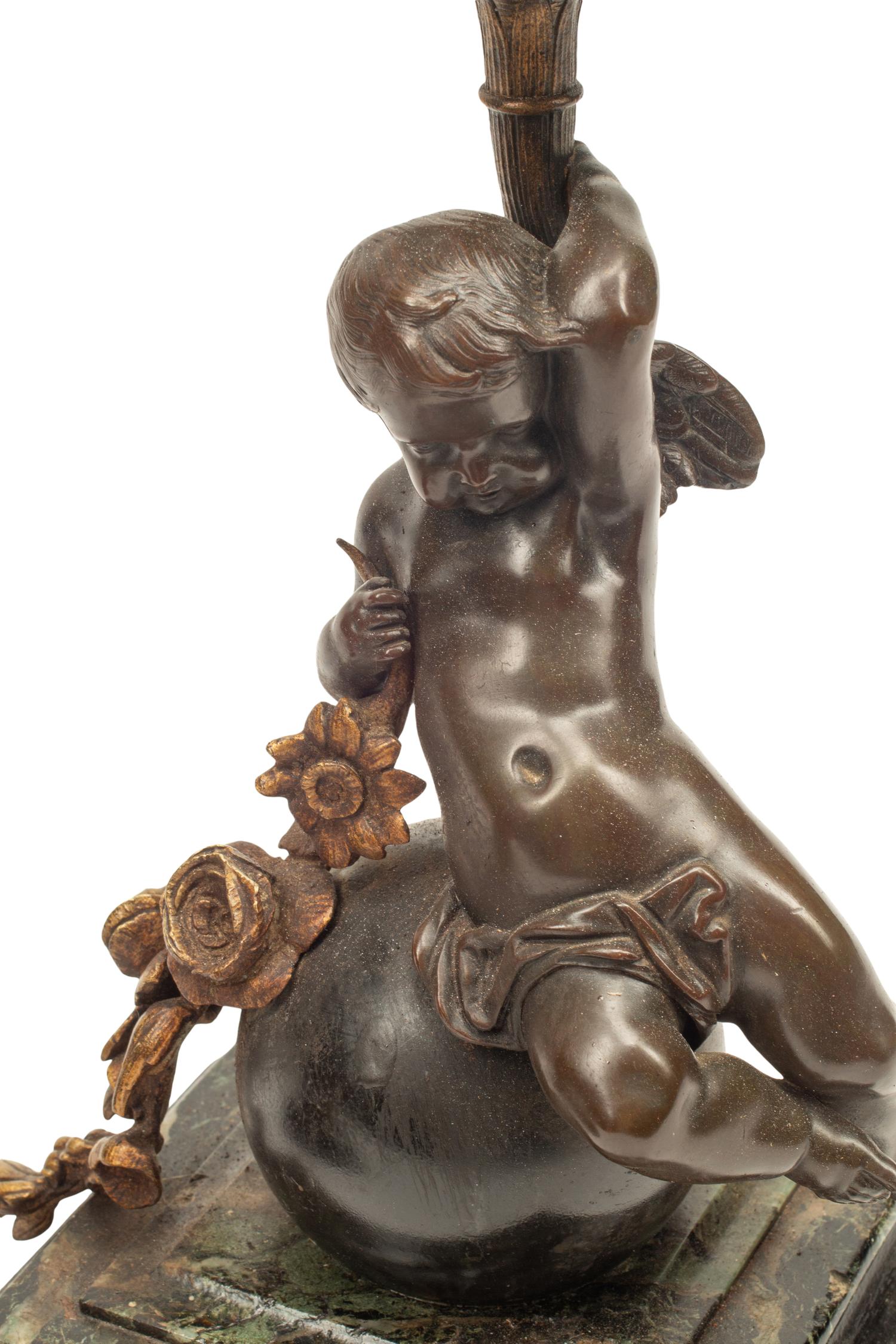 A Pair of Continental Gilt and Patinated Bronze and Marble Figural Candlesticks