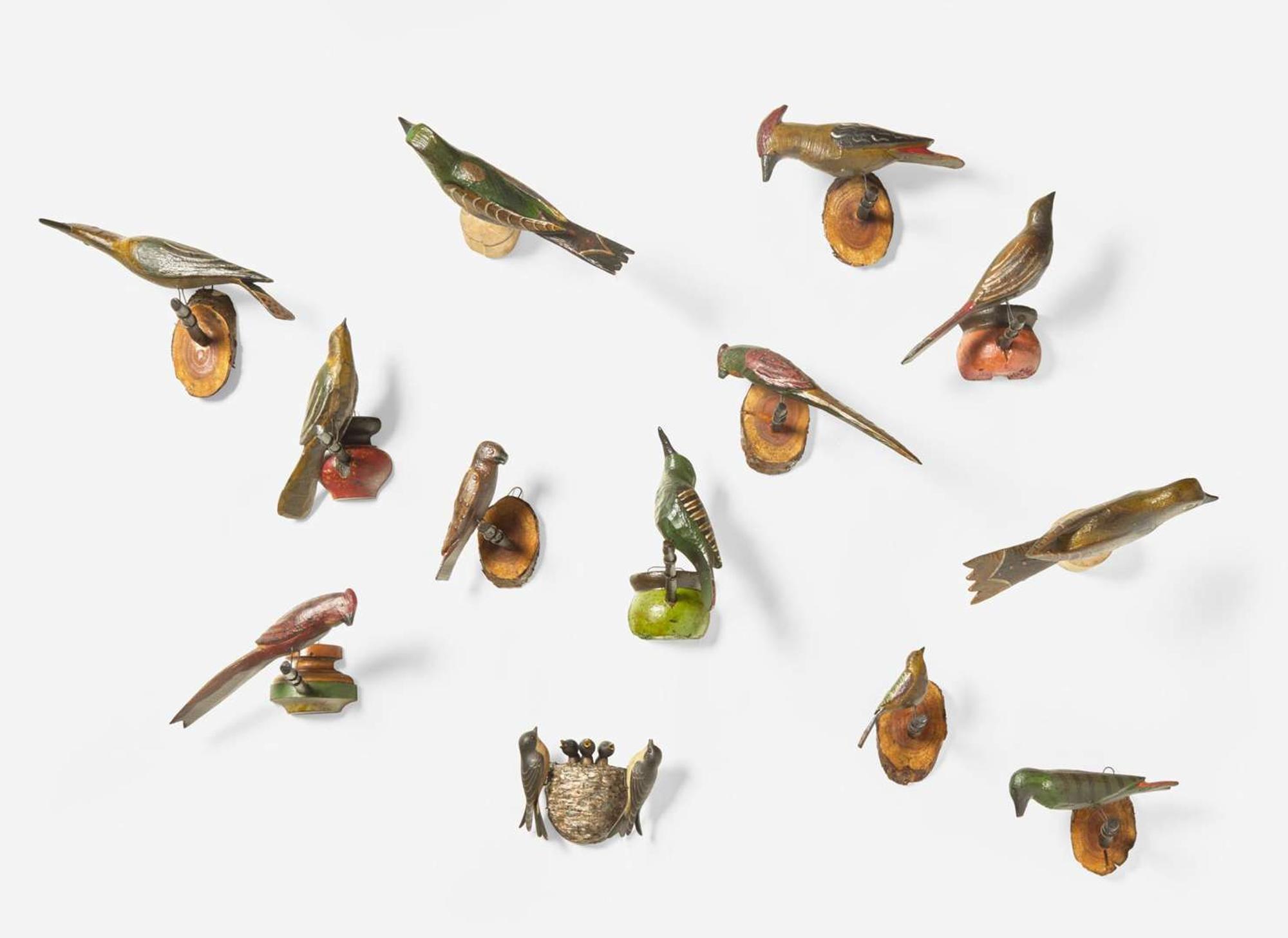 A group of thirteen carved and painted birds or bird groups