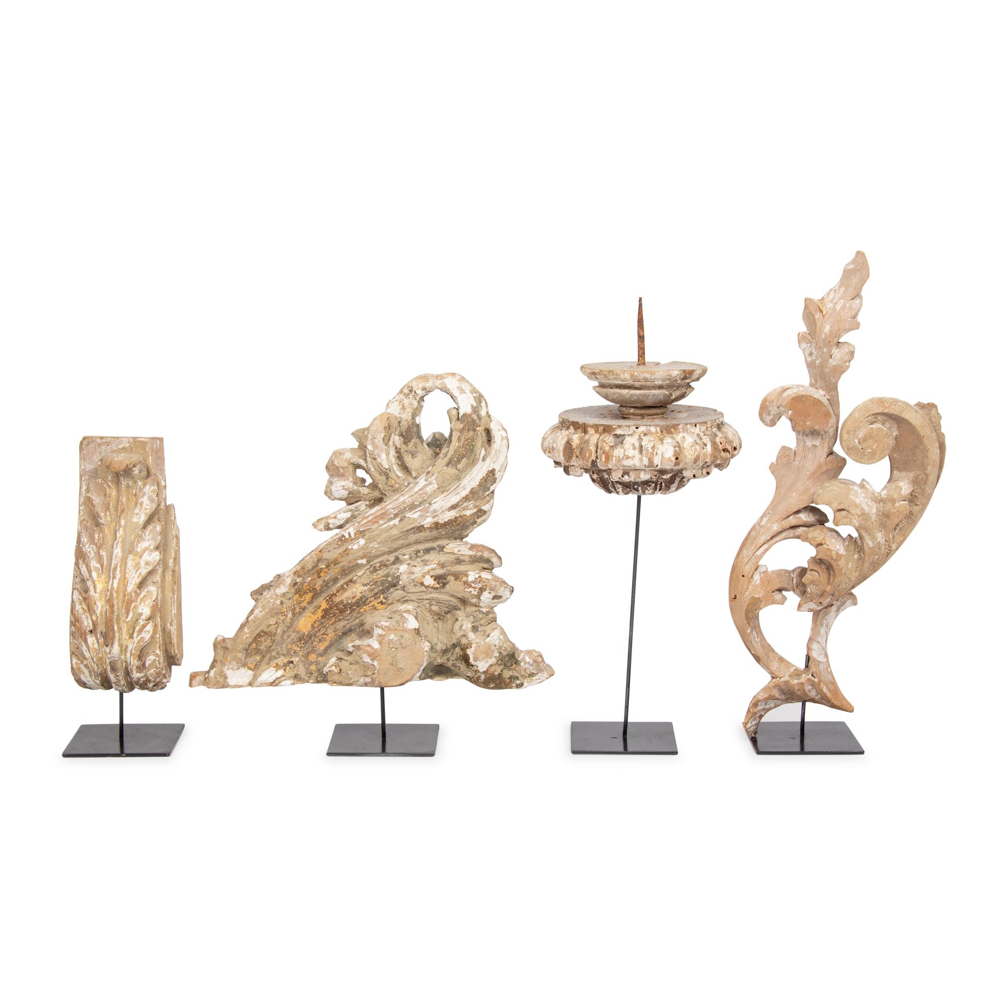 A Group of Four Carved and Painted Wood Fragments on Stands