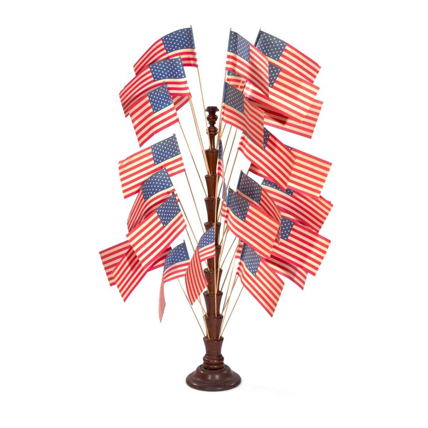 [FLAGS]. A turned wooden flag tree stand. Late 19th-early 20th century.