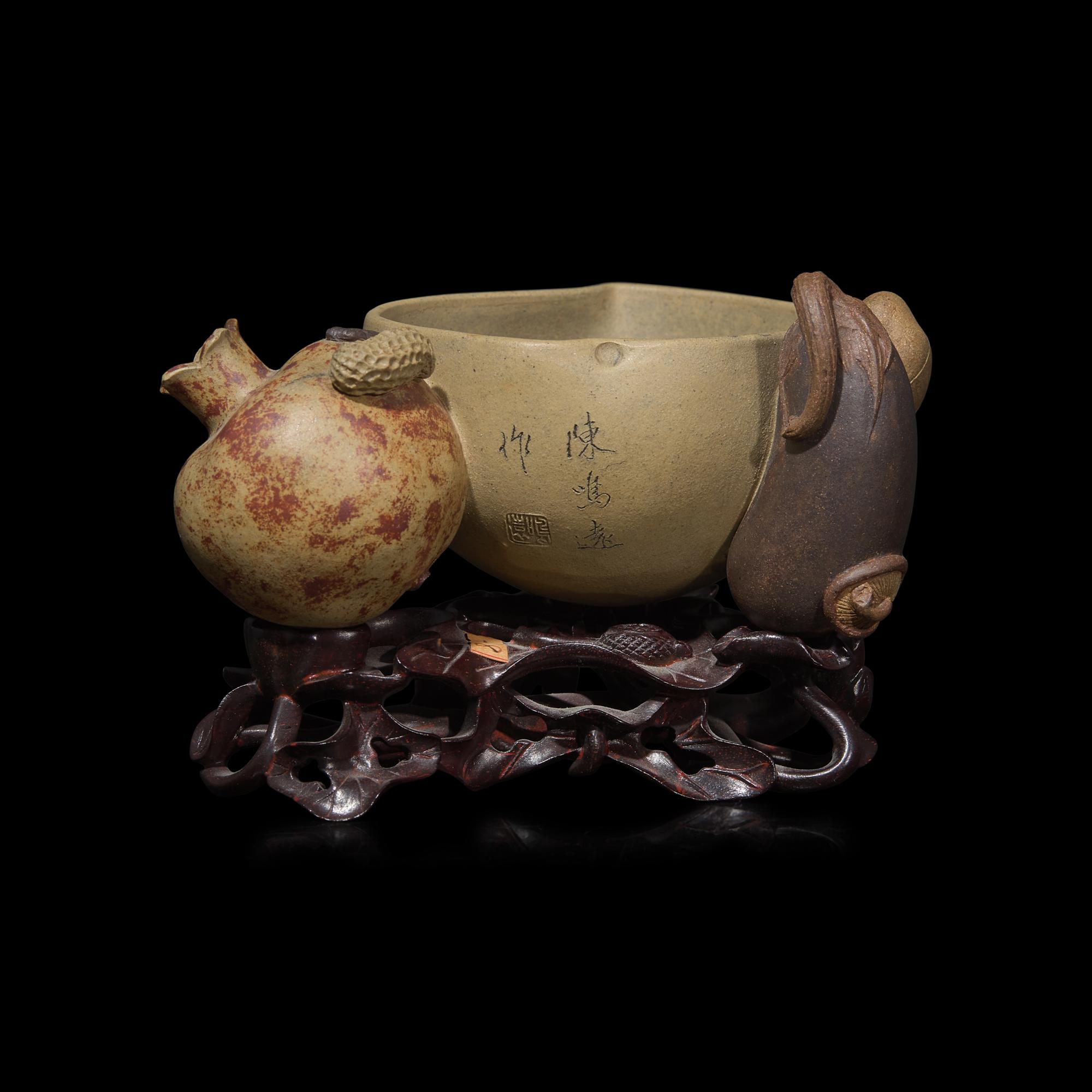 A Rare Chinese Yixing 'Peach and Pomegranate' Coupe Inscribed 'Chen Minyuan Zuo' and Carved Wood Stand 陳鳴遠款段泥紫砂桃榴杯