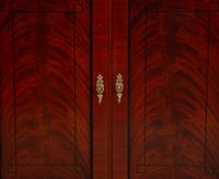 A Late Regency Style Figured Mahogany Sideboard with Carved Ebonized Pilasters